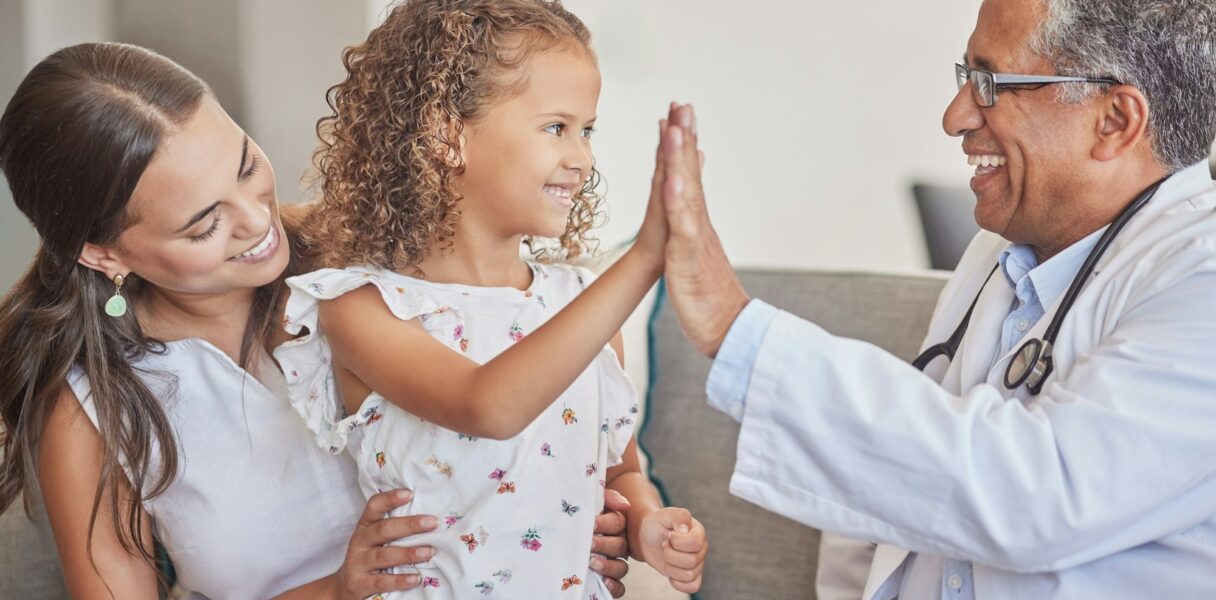 Family, medical and high five with girl and doctor in consulting hospital room for healthcare, trus