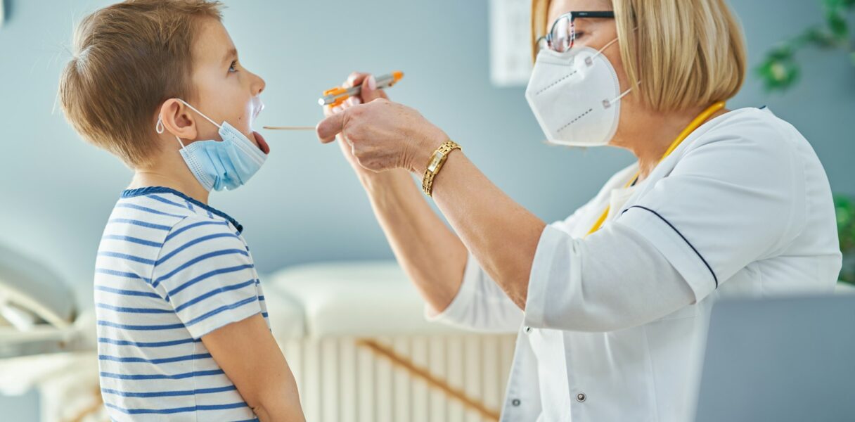 Pediatrician doctor examining little kids in clinic